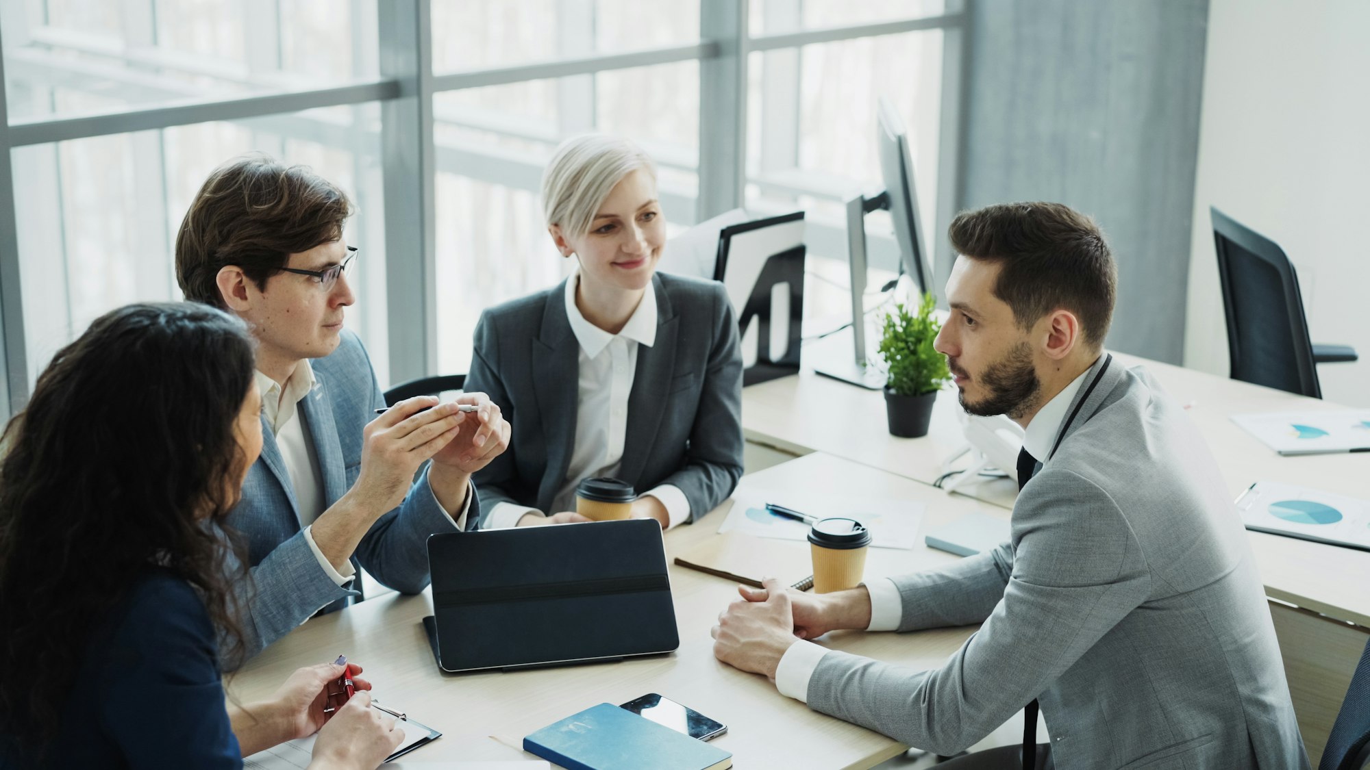 0M24 Group leadership in an executive boardroom meeting